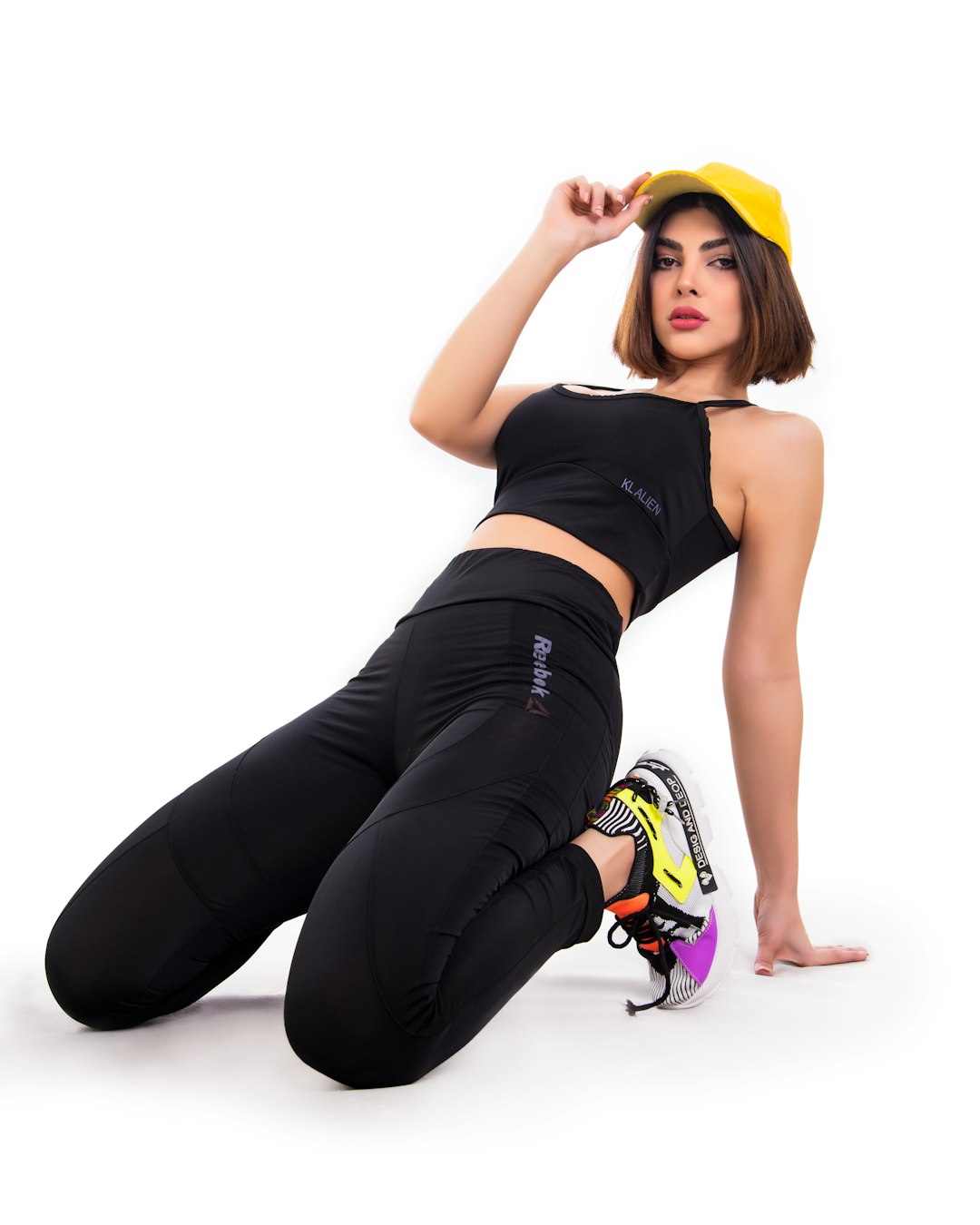 a-woman-in-a-yellow-hat-and-black-pants-koswrxdkpsg
